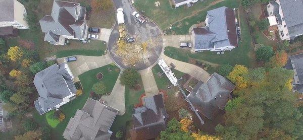 Tree service gives view from above of tree removal with crane in Kansas city.