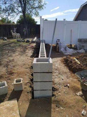 Property dividing wall with pillars and lighting