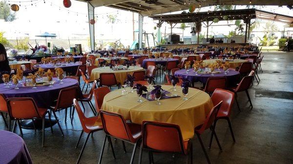 Covered outdoor patio setup includes full bar, band stage and cook shack.