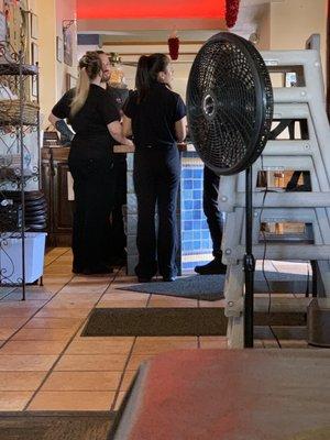 Front counter staff all crowded around the register. Sherrie was helping everyone on the one side of the restaurant-seating.