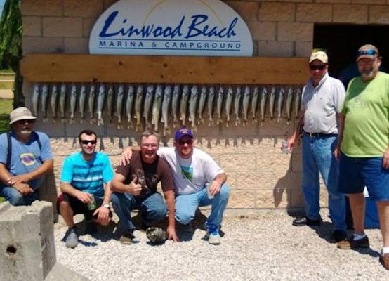 Happy clients with their walleye caught in Saginaw Bay