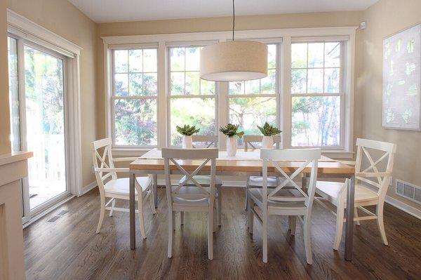 Strategically staged dining room showcases the large windows and contemporary light fixture.