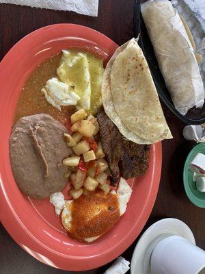 Huevos divorciados with homemade tortillas and beef fajita breakfast