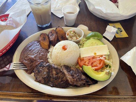 OK it was salad with avocado withbeans and rice and plantains cheese with meat  juice was fresh jugo de Nance