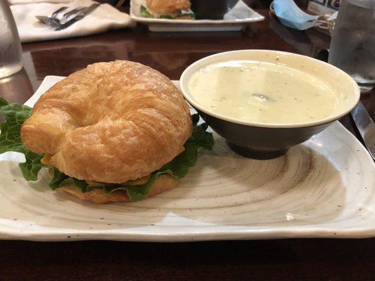 Tuna salad sandwich on a croissant with famous Broccoli Cheddar soup