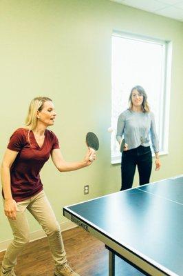 Clients playing ping pong in the recreation room