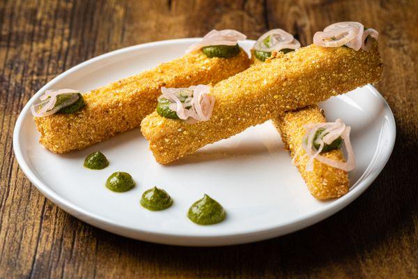 Crispy corn polenta with basil sauce and pickled shallots