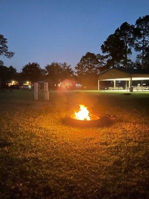 Enjoying a fire with the pavilion in the background