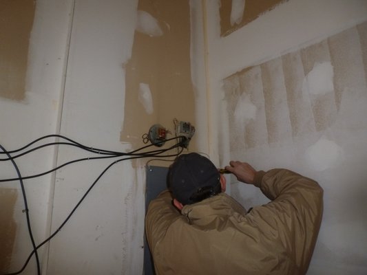 Mark's undoing the panel box to see what the wiring looks like... we do that every day.