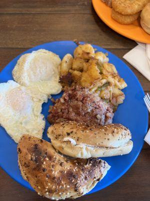 Corned beef hash with home fries and bagel.