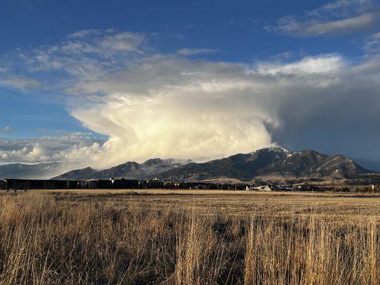 View of the Bridger Mountain Range with a snow shower.