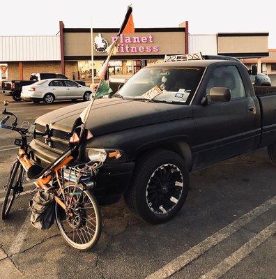 Port quarter view of my eBikeKit-assisted CruzBike leaning against good friend RAM in Planet Fitness parking lot.