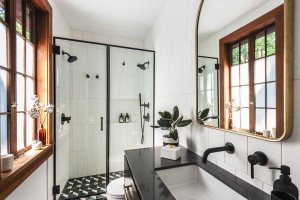 Classic black and white primary bath with bold pattern tile