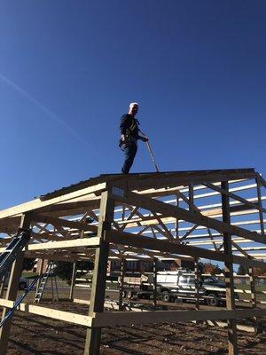 Putting steel on a pole shed