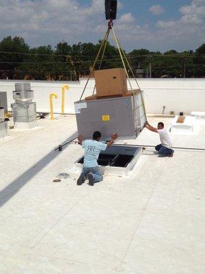 A couple of our guys installing a new roof top AC on a commercial building