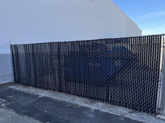 Chain link fence with black slats