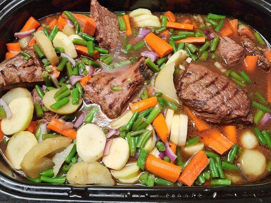 Grillled roast and fresh veggies in beef broth slow cooked for max flavor