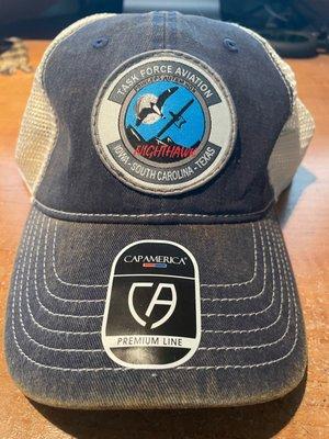 Trucker cap with embroidered patch for Iowa National Guard.