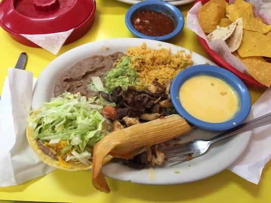 My yummy sampler platter. Guac tamale queso tostada rice and refried beans. Comes with two tortillas and chicken beef fajitas.