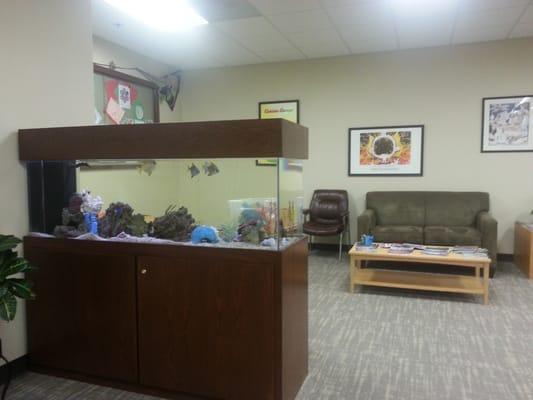 Waiting room. Play area for kids with fish tank. Comfy grownup seating.