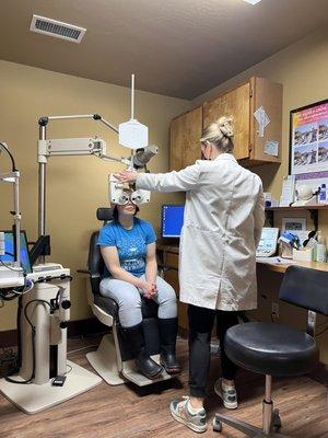 "Doc Alex" making Anicia feel comfortable during her eye exam.