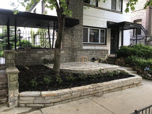 cemented natural stone drywall and raised flagstone patio.