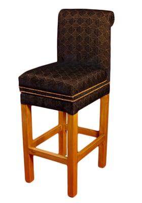 It has a small rolled back, comfortable padded seat with a border and tapered, finished legs.