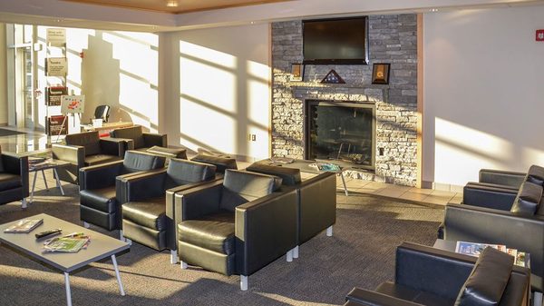 Comfortable Service Waiting Area with Complimentary Wifi, TV, Fireplace, Charging Station and Children's Play Area.