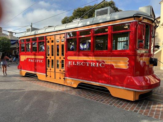 Red car trolley near park entrance