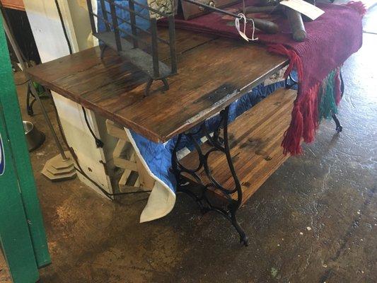 Side table made with old 100+ year old factory door set on old sewing table base.