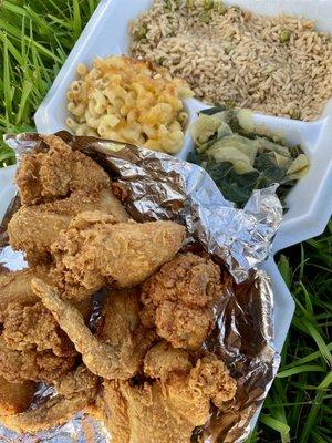 Fried wings with fried rice, collard greens and cabbage plus Mac & cheese