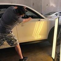 One of our technicians, Jesse, pushing dents out of the door.