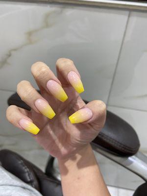 Ombre nude pink and yellow, you can show her the photo if you want the exact same color, she did my nails plenty of times so she'll remember