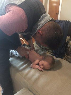 Chiropractic adjustment of a baby.