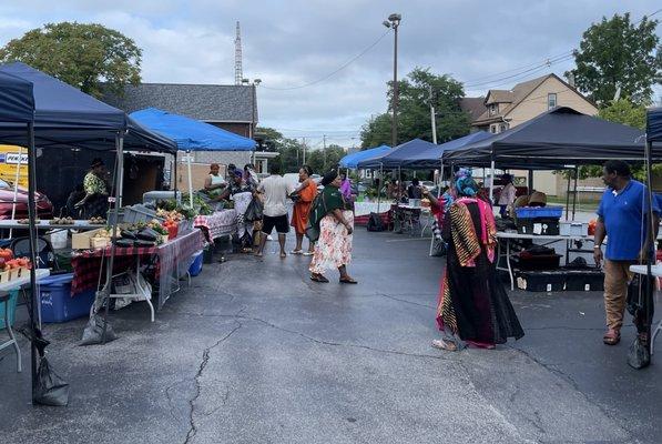 Market vendors with fresh veggies