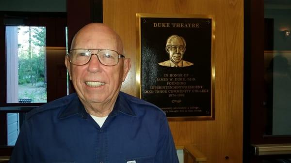 Dr Duke posing with the plaque honoring him.