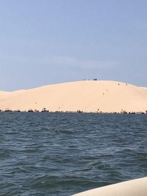 Those tiny dots on the sand are people climbing up and running down the sand dunes.