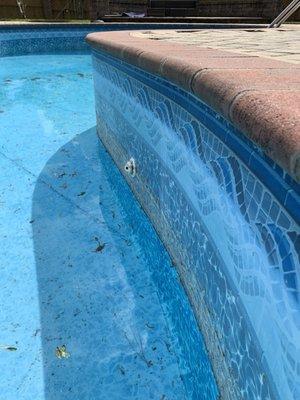 Torn pool liner.