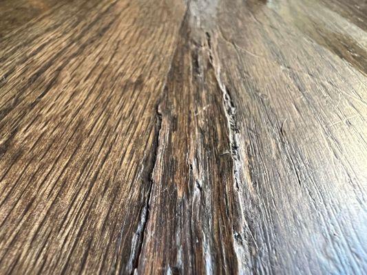 Some of the cracks and buckles happening in the dining room where new wood was installed and is also buckling/heaving and wavy.