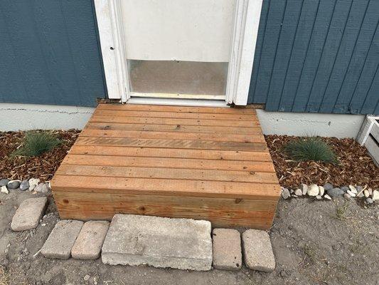 Finished stoop with pressure treated wood (he's not responsible for the stones and landscaping - ignore them!)