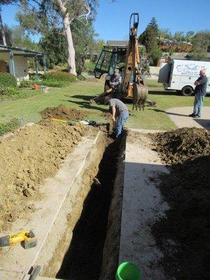 Adam surveying trench area.