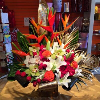 Our tropicals from Costa Rica Thailand orchids Ecuadorean lilies and Colombian roses  designed to wrap your loved one withLOTS OF LOVE