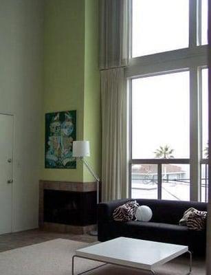 Living room with ceiling to floor windows and a fireplace