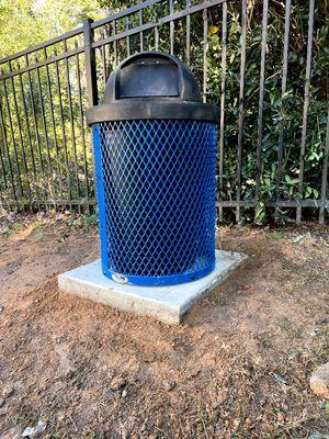 Small concrete pad with trashcan mount