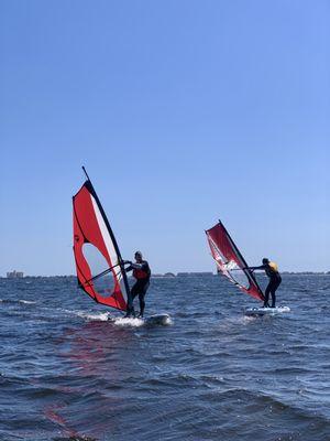 Father and daughter doing great during their windsurfing lesson.