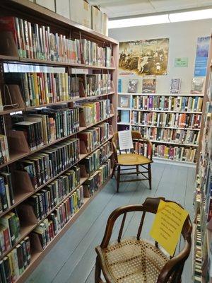 An overabundance of chairs for sale (donation) in the Adult Fiction section, Brooklyn Town Library, CT, 2022