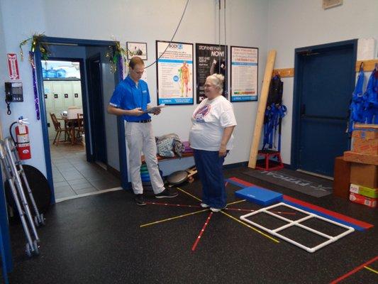 Nathan Macaluso, PT, DPT performing a free fall risk assessment.