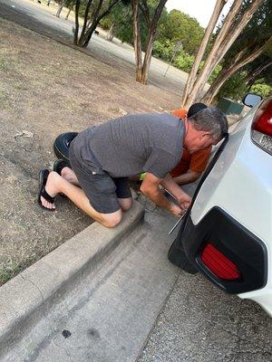 My friends changing my tire at the dog park last night! I have good friends!