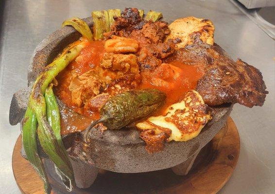 MOLCAJETE: Served on a  bed of rice, steak, chicken, carnitas, chorizo, shrimp and queso fresco