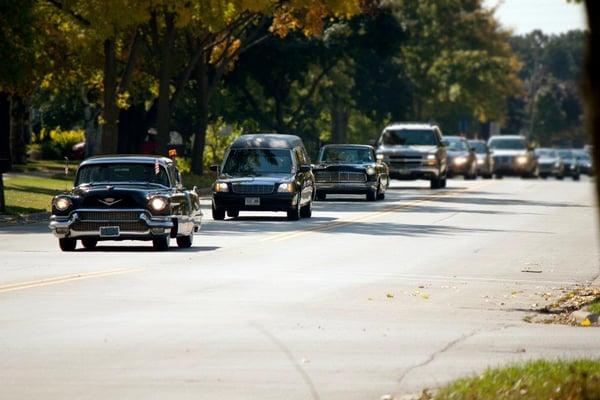 The Ryan Funeral Home fleet leading a procession from church.